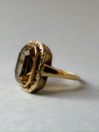 Gold and Citrine solitaire ring with bezel setting, close up of side view