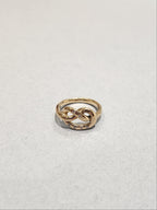 Gold ring in a knotted design, with 6
Round Diamonds flush set into the gold. 9ct Yellow gold. Pretzel ring.  Top view of ring. 