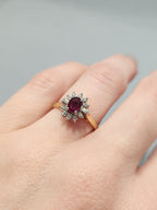 Antique cluster ring with Ruby oval centre stone and diamond halo, 
