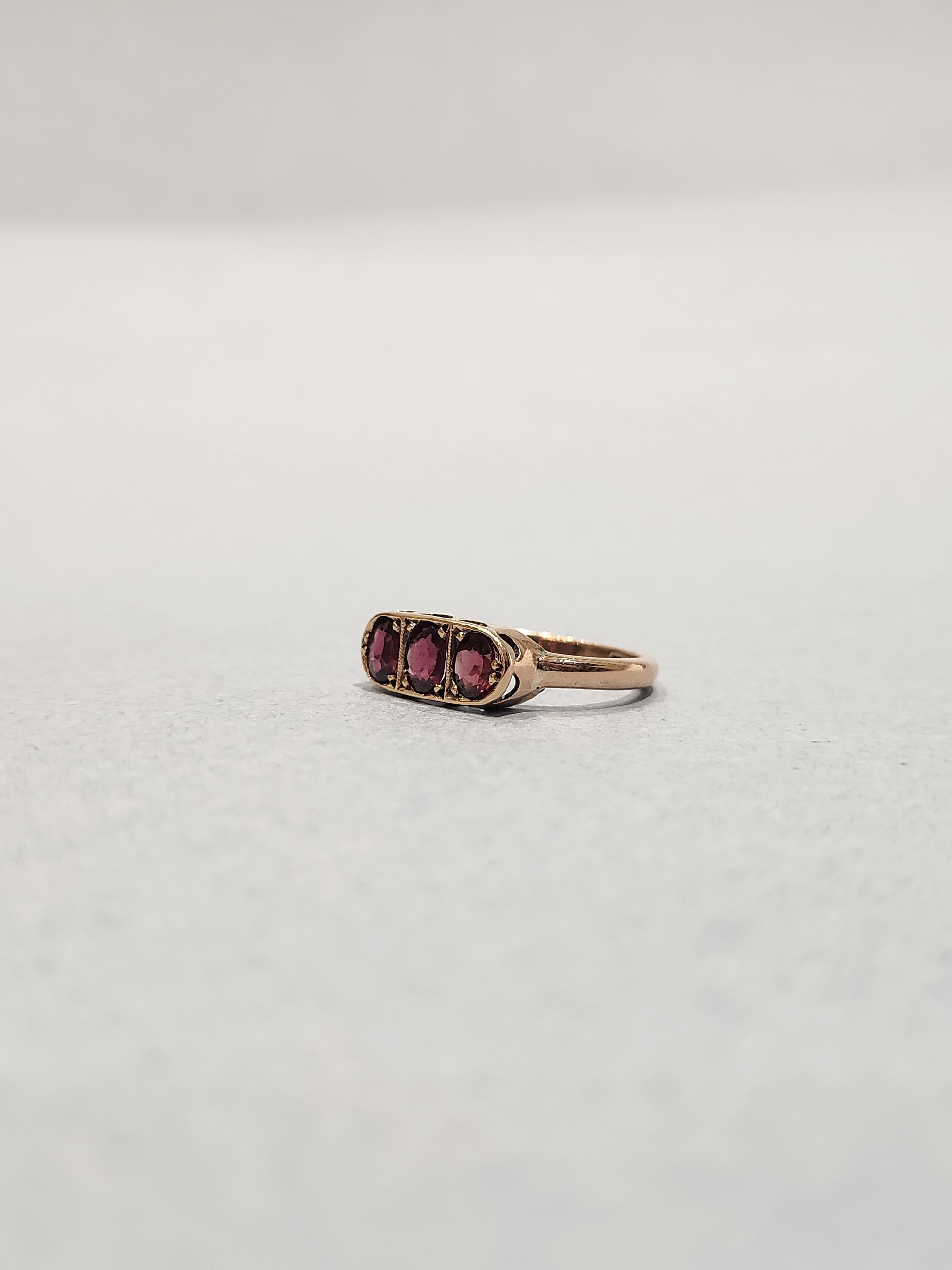 Trilogy ring, with oval pink garnets, bead set