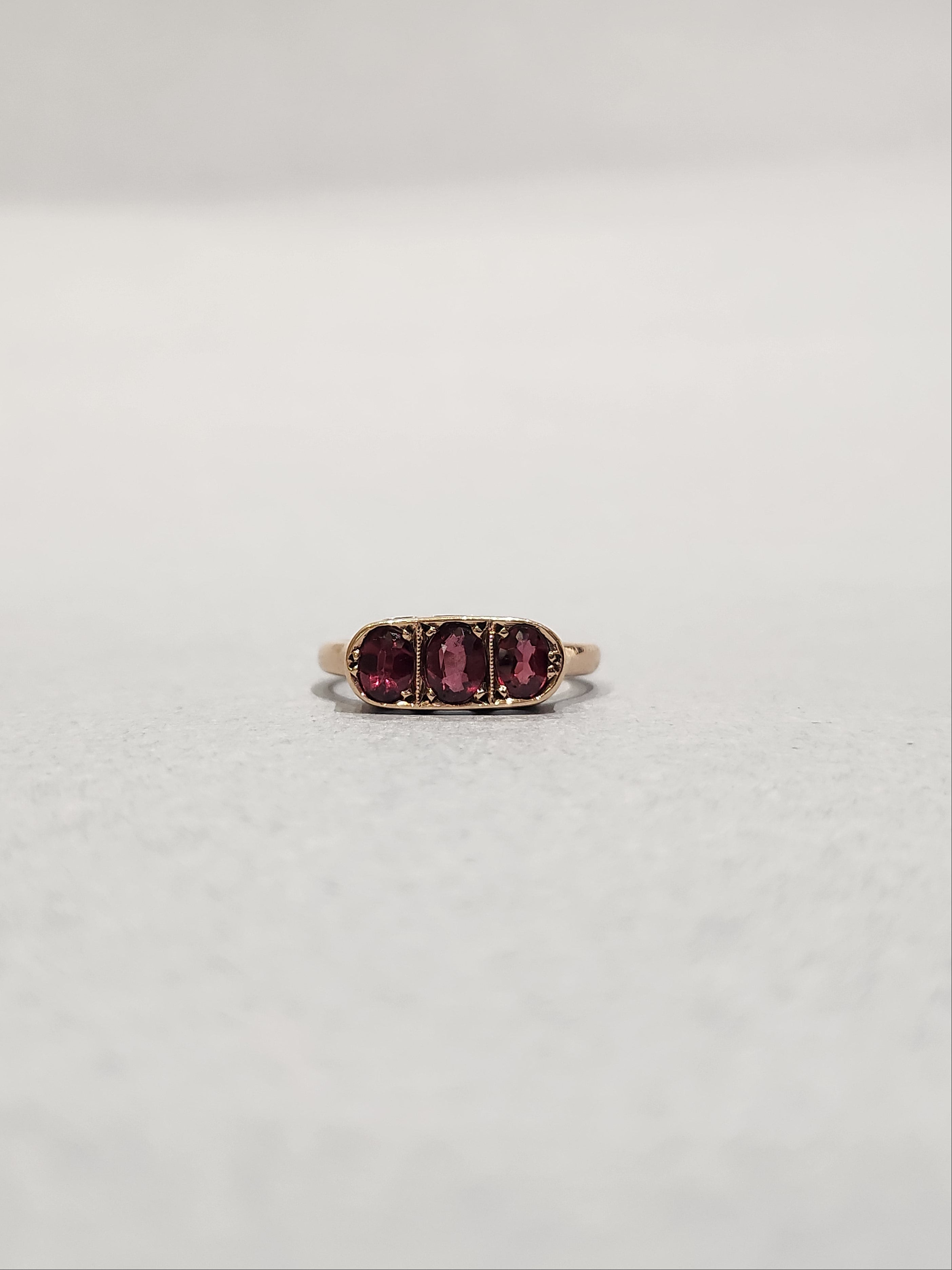 Three stone garnet ring, with bezel setting and bead setting.  