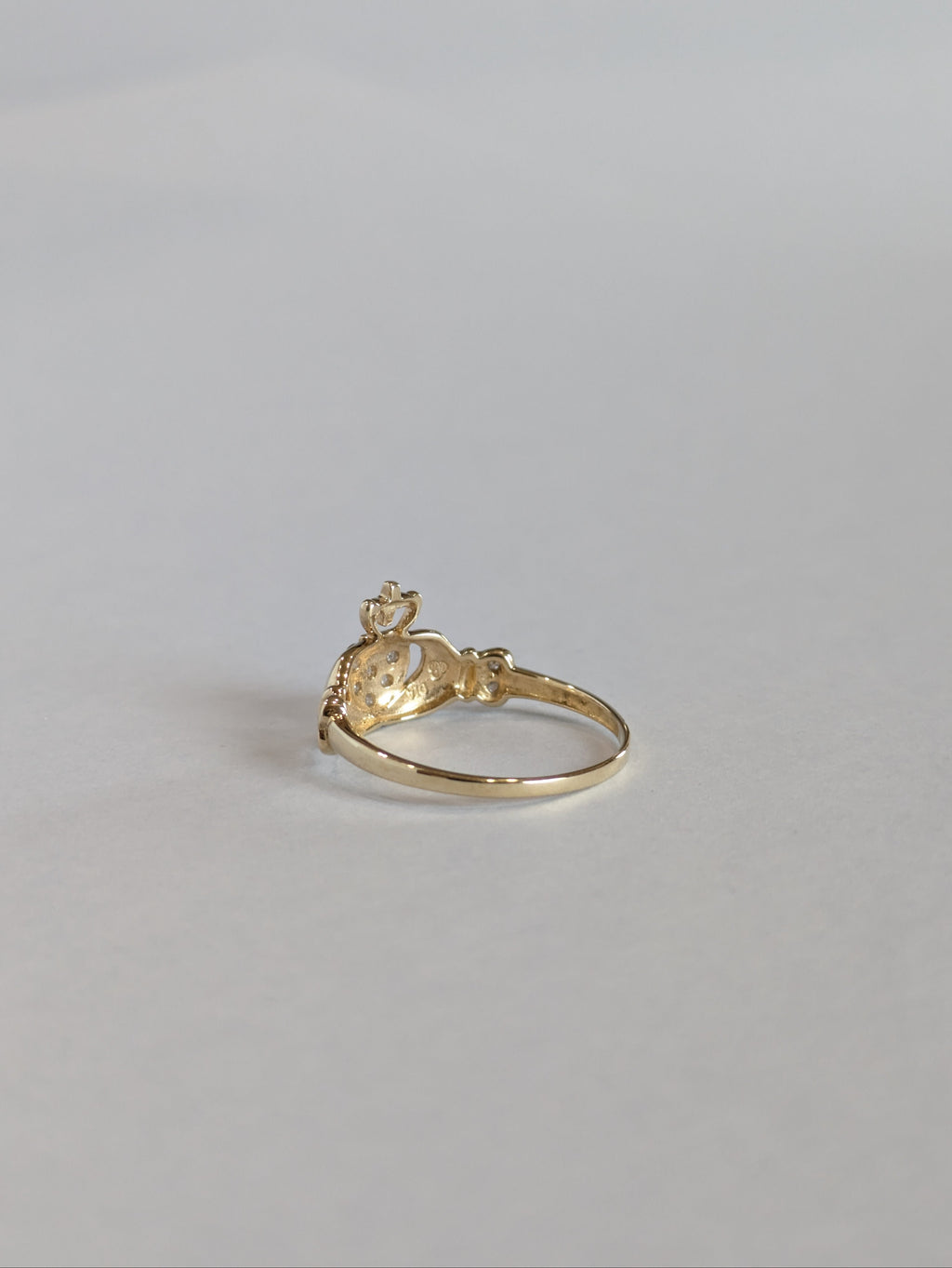 The inside shank and setting of a vintage yellow gold claddagh ring