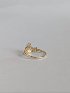 The inside shank and setting of a vintage yellow gold claddagh ring