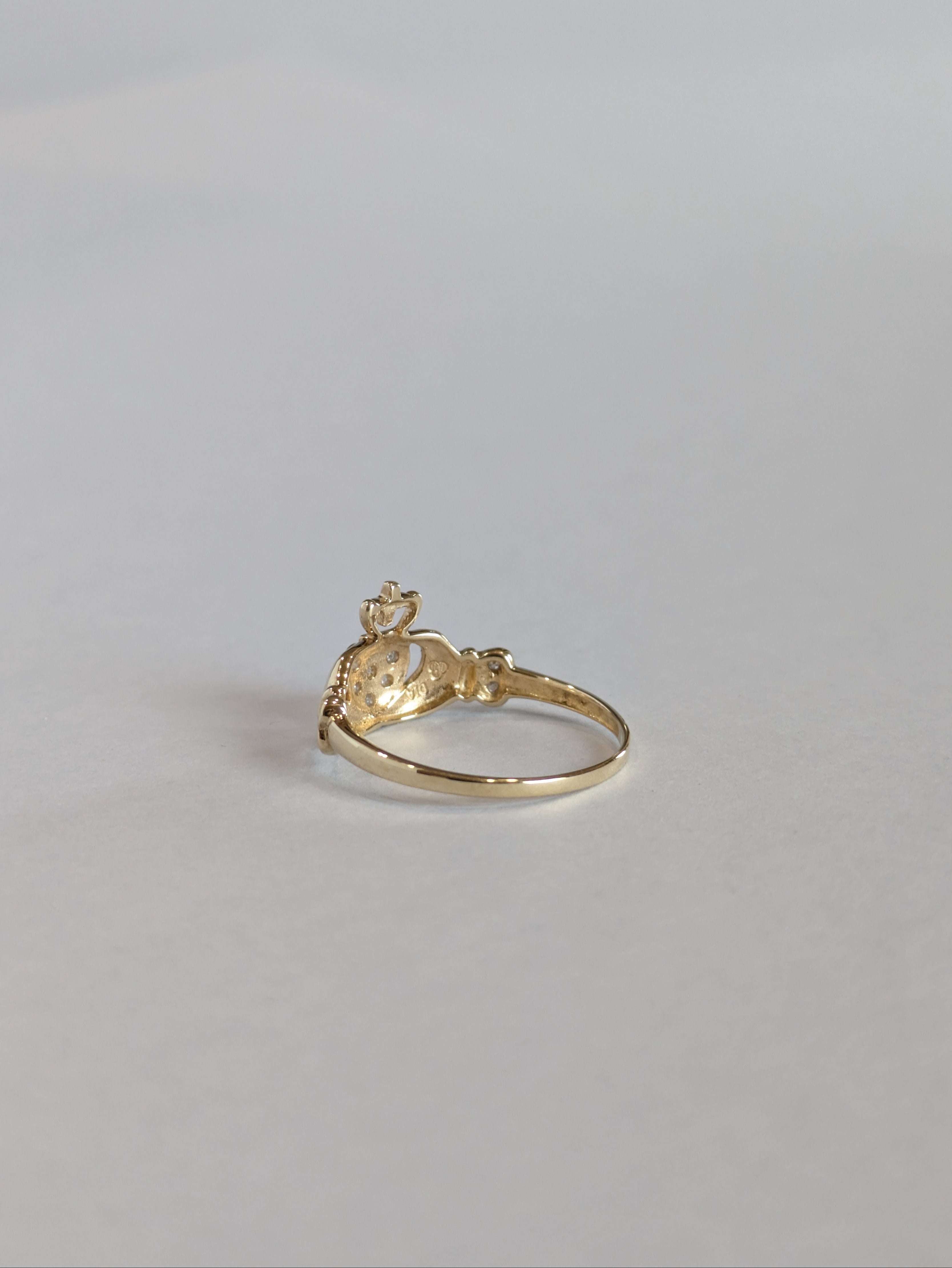 The inside shank and setting of a vintage yellow gold claddagh ring
